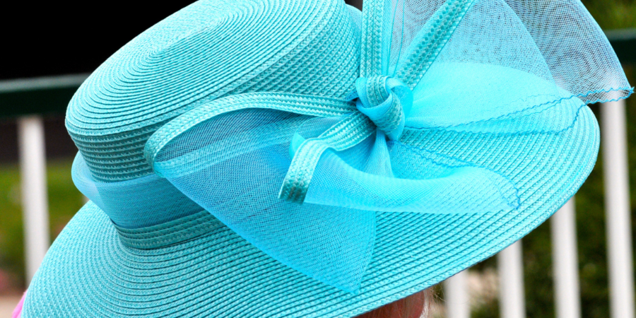 woman in turquoise hat with bow